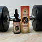 Mako's Cordyceps mushroom tincture in an amber glass bottle with dropper, box and natural Cordyceps in gym