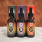 Three bottles of mushroom supplement. Lions mane, Cordyceps and Reishi with droppers in front of their packaging on a textured surface.