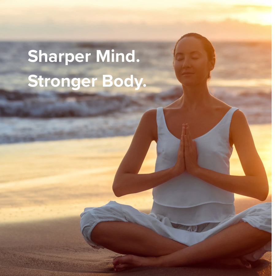Woman meditating on a beach with text 'Sharper Mind. Stronger Body.'