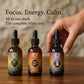 Three Mako mushroom supplement bottles on a wooden surface with a hand reaching for one of them. Lions mane, Cordyceps and Reishi