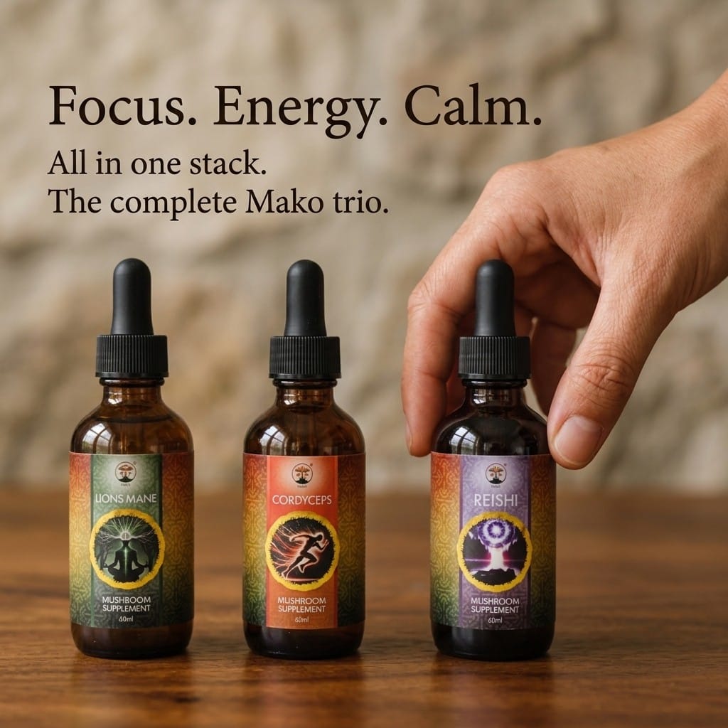 Three Mako mushroom supplement bottles on a wooden surface with a hand reaching for one of them. Lions mane, Cordyceps and Reishi
